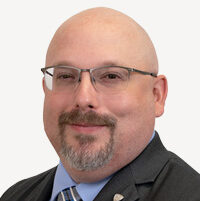 Headshot of Travis Rhoades